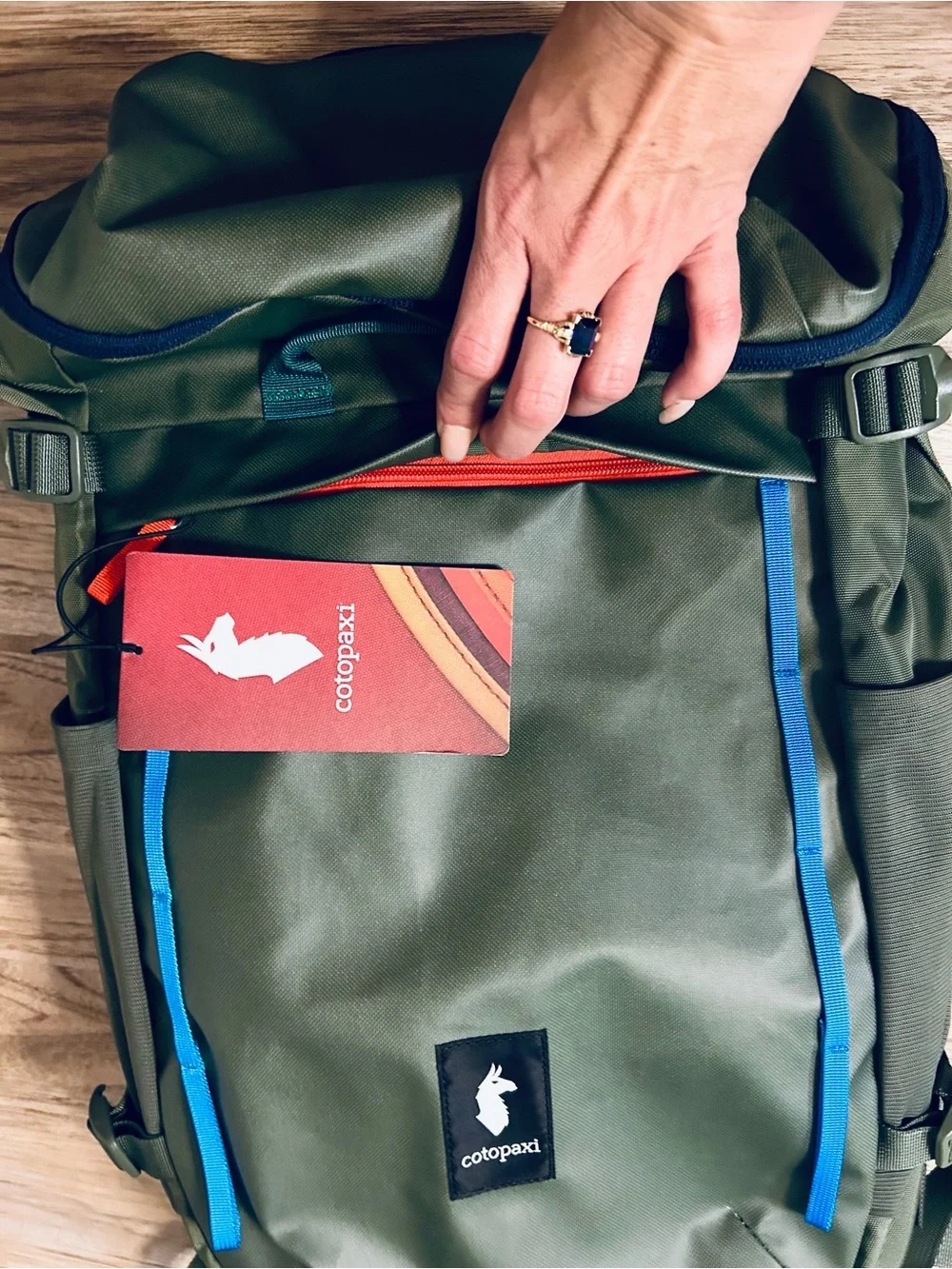 cotopaxi Olive Green Backpack with Blue and Teal Accents